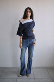 TWISTED BOOTS CUT DENIM JEANS