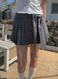 Chete Knot Check Pleats Mini Skirt