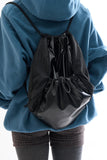 Metallic panel drawstring backpack