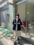 Naoki color matching lettering over short sleeve hood zip-up