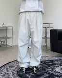 Has wide pin tuck cotton pants