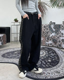 Heron embroidered denim pants