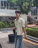 Leviron Two-Pocket Cut-out Collar Short-Sleeve Cardigan
