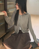 Nilla cut-out round neck button long-sleeved cardigan