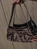 Oval buckle shoulder bag