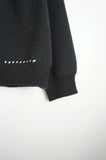 stitch over black cardigan