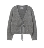 Bow over cardigan