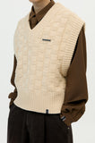 v-neck knit vest and brooch